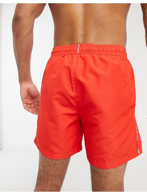 Calvin Klein medium length swim trunks in red