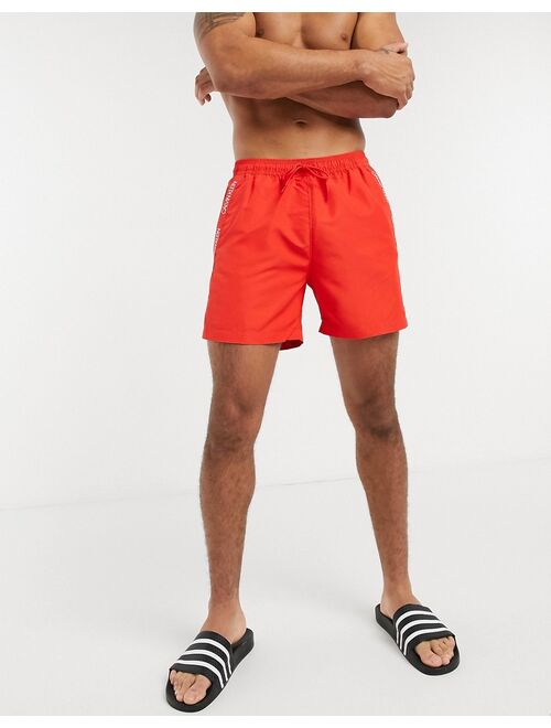 Calvin Klein medium length swim trunks in red