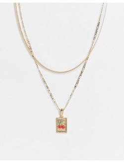 multirow necklace with cherry tag pendant in gold tone