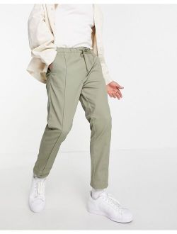 skinny chinos with elasticized waist and pin tuck in light khaki