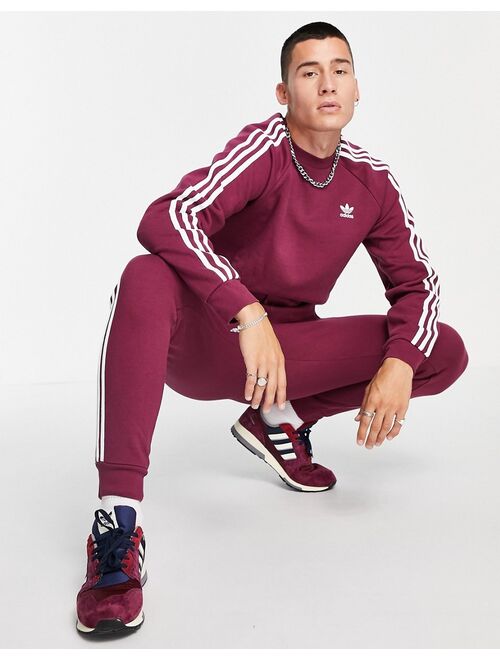 Adidas Originals Originals adicolor three stripe sweatshirt in plum