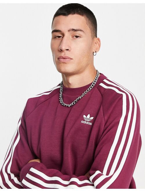 Adidas Originals Originals adicolor three stripe sweatshirt in plum