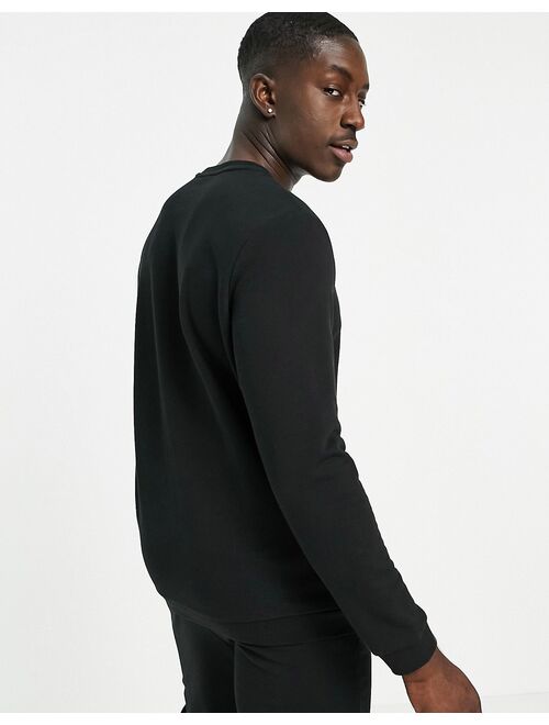 Puma repeat cat logo sweatshirt in black - exclusive to ASOS