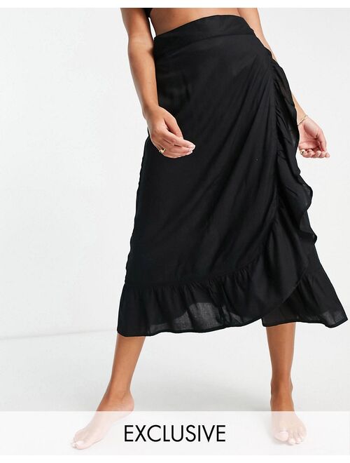 Esmee Exclusive frill beach wrap skirt in black