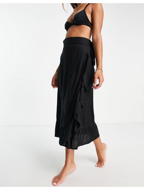 Esmee Exclusive frill beach wrap skirt in black