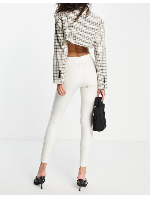 Topshop faux leather skinny pants with front hem slits in off white