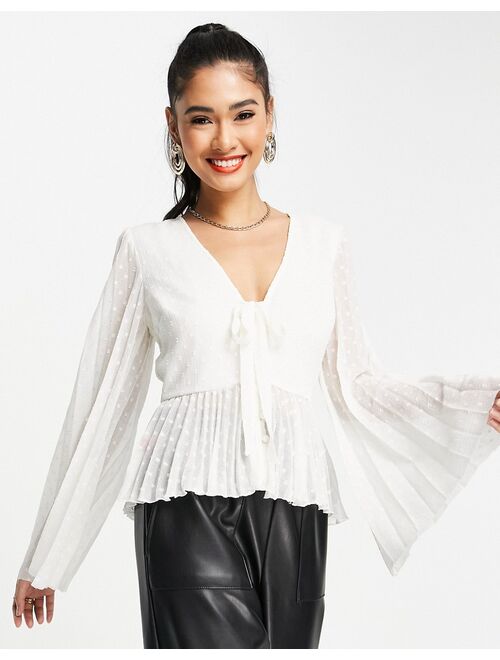 ASOS DESIGN textured pleated peplum shirt with button and tie detail with long sleeve in ivory