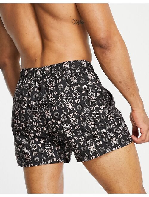 ASOS DESIGN swim shorts in black with HAND DRAWN design short length