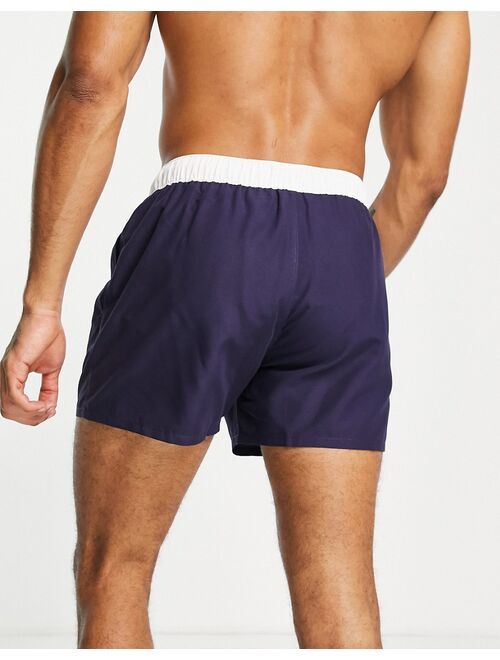 ASOS DESIGN swim shorts in navy with white tipping