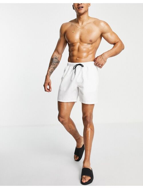 ASOS DESIGN swim shorts in white in mid length