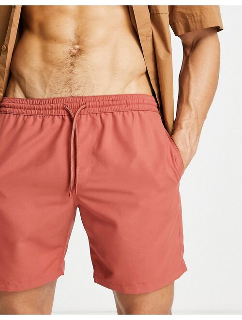 ASOS DESIGN swim shorts in rust red mid length