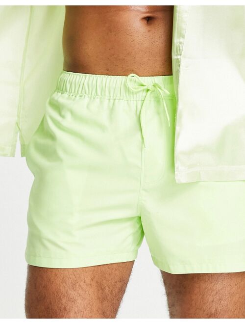 ASOS DESIGN swim shorts with pin tuck in light green short length