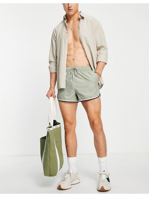 ASOS DESIGN runner swim shorts in green with contrast binding