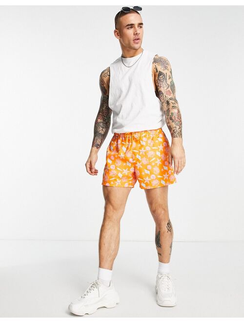 ASOS DESIGN sea shell print swim shorts in orange