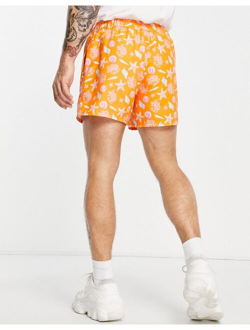 ASOS DESIGN sea shell print swim shorts in orange