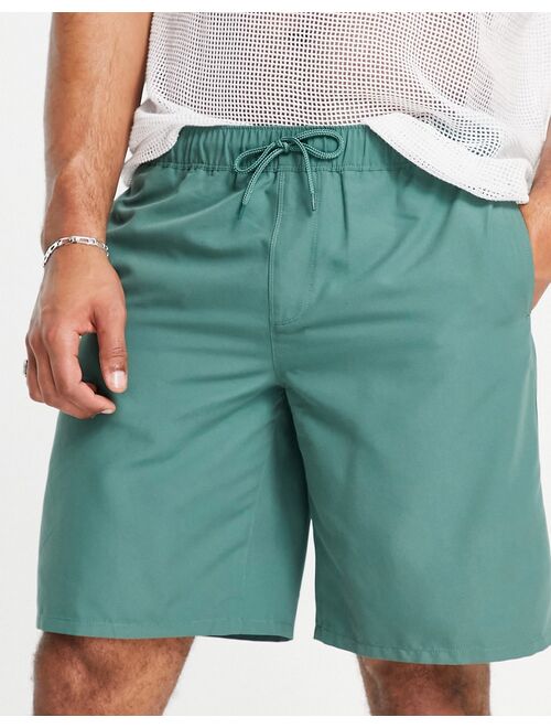 ASOS DESIGN swim shorts in dark green long length