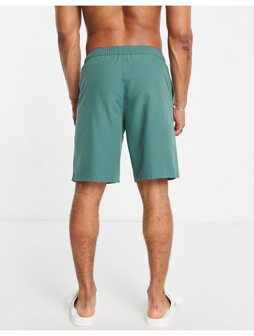 ASOS DESIGN swim shorts in dark green long length