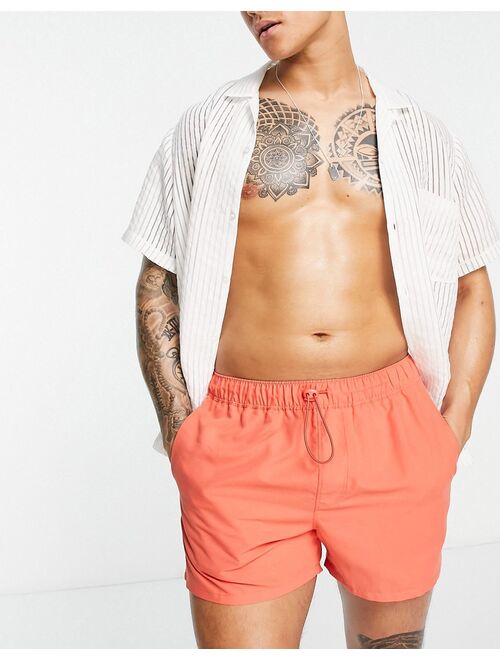 ASOS DESIGN short length swim shorts with toggle in red