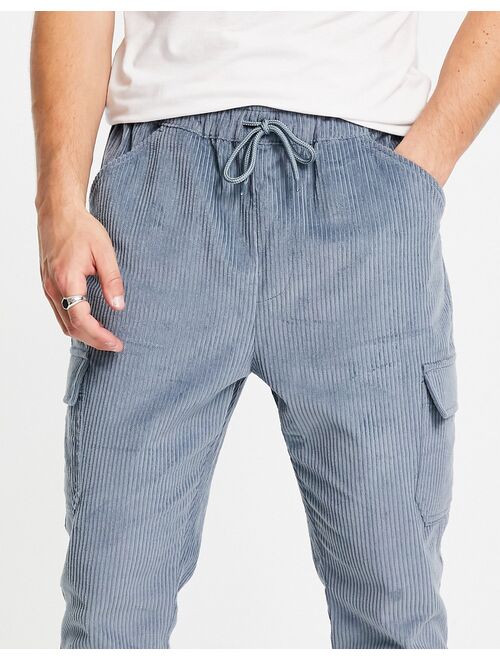 ASOS DESIGN tapered fit cargo pants in cord in blue