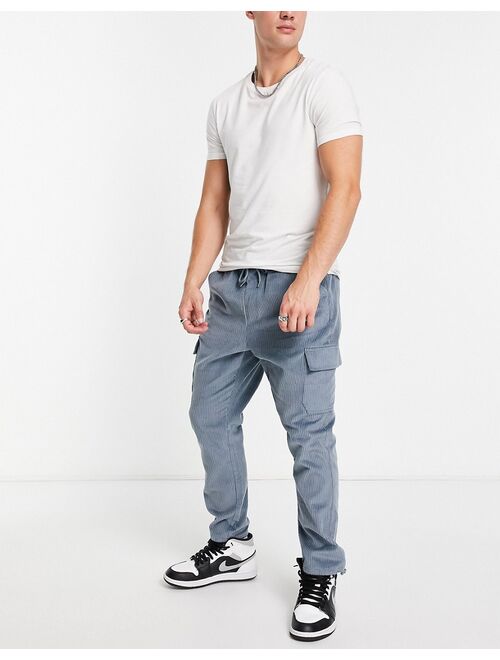 ASOS DESIGN tapered fit cargo pants in cord in blue