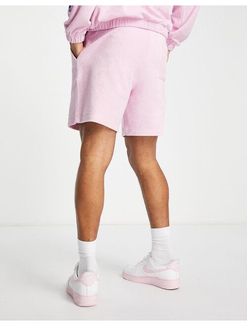 ASOS DESIGN relaxed terrycloth shorts with embroidery detail in pink