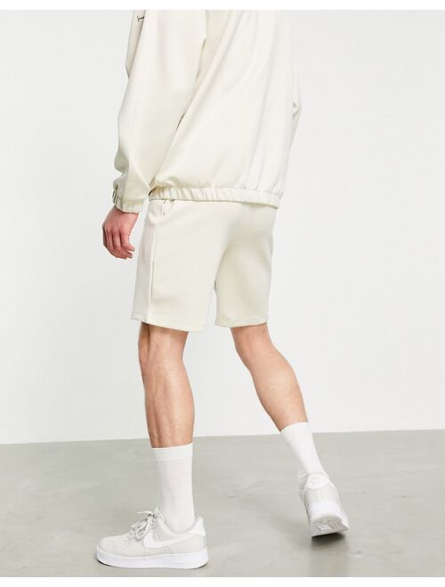 ASOS DESIGN set oversized scuba shorts with Roman numerals embroidery