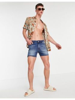 skinny denim shorts in mid wash blue in shorter length