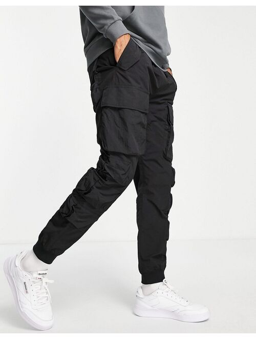 Buy Topman relaxed nylon multi pocket cargo pants in black online