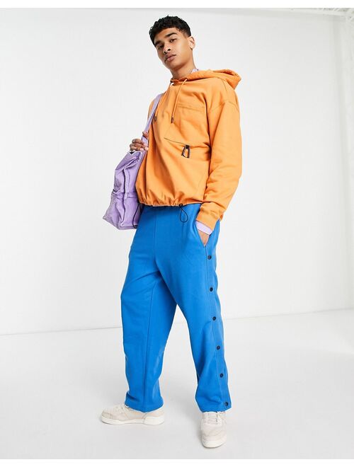 ASOS DESIGN oversized hoodie with toggle details in orange