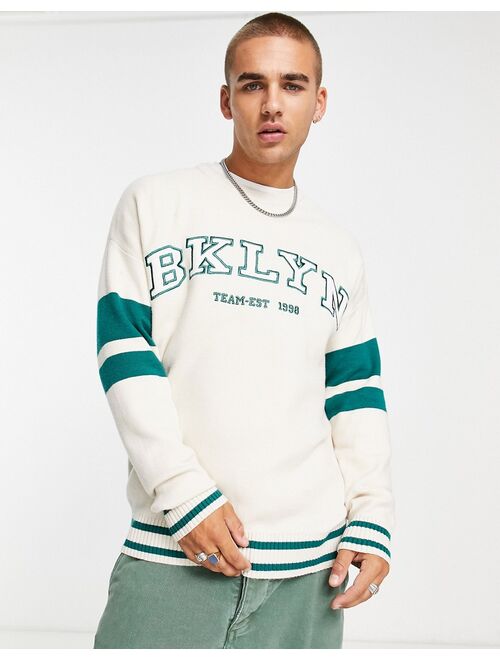 Bershka collegiate Brooklyn knit crew neck sweater in ecru