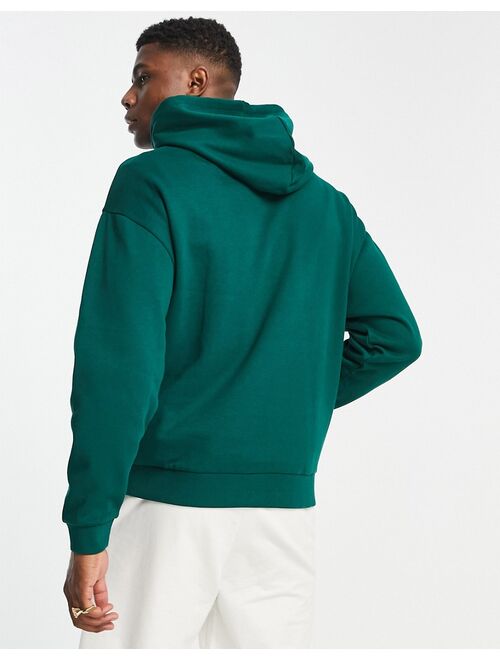 ASOS DESIGN oversized hoodie in dark green with varsity Oakland print