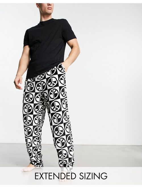 ASOS DESIGN pajama set with t-shirt and pants in black with fleece printed bottom