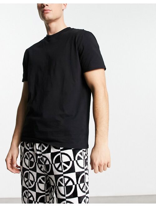 ASOS DESIGN pajama set with t-shirt and pants in black with fleece printed bottom