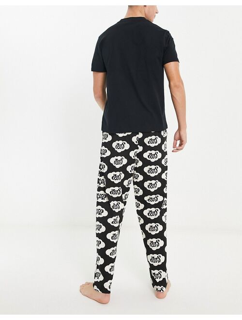 ASOS DESIGN pajama set in black with t-shirt and pants in sleepy print