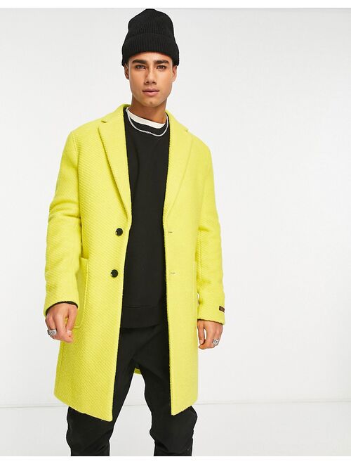 Devils Advocate longline coat in yellow