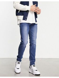 warp skinny fit jeans in mid blue