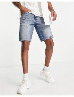 slim denim shorts in mid wash tint with raw hem