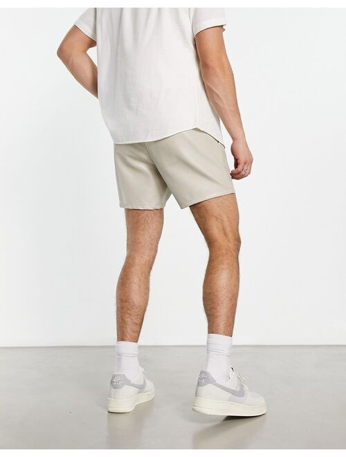 ASOS DESIGN slim fit leather look shorts in beige