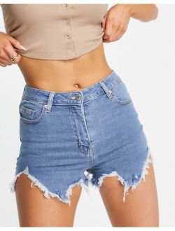 Parisian distressed denim shorts with rips in mid blue