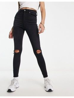 ultimate skinny jeans in black with knee rips