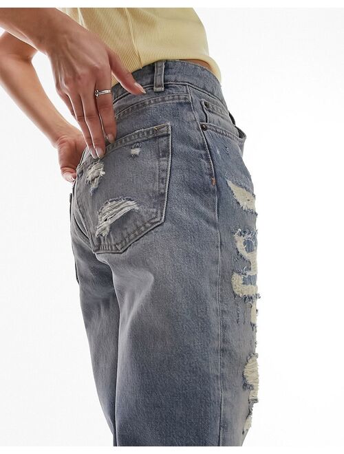 Topshop Dad jeans with extreme rip & repair in mid blue