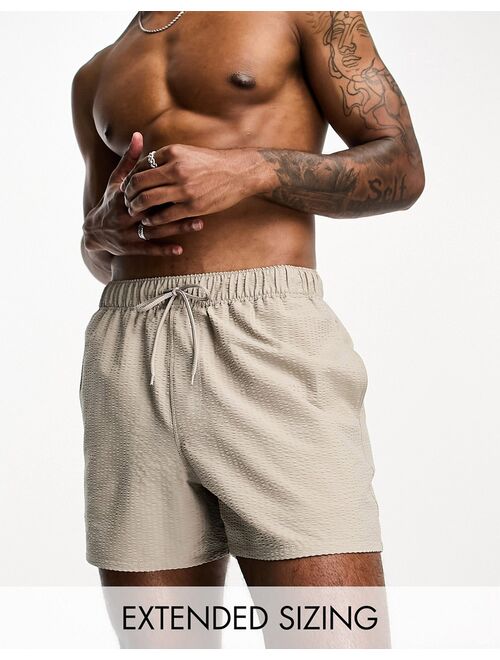 ASOS DESIGN seersucker swim shorts in short length in beige