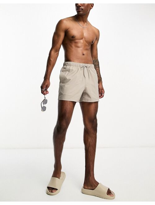 ASOS DESIGN seersucker swim shorts in short length in beige