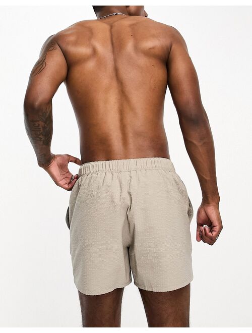 ASOS DESIGN seersucker swim shorts in short length in beige