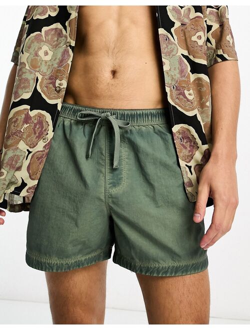 ASOS DESIGN swim shorts in short length in washed green