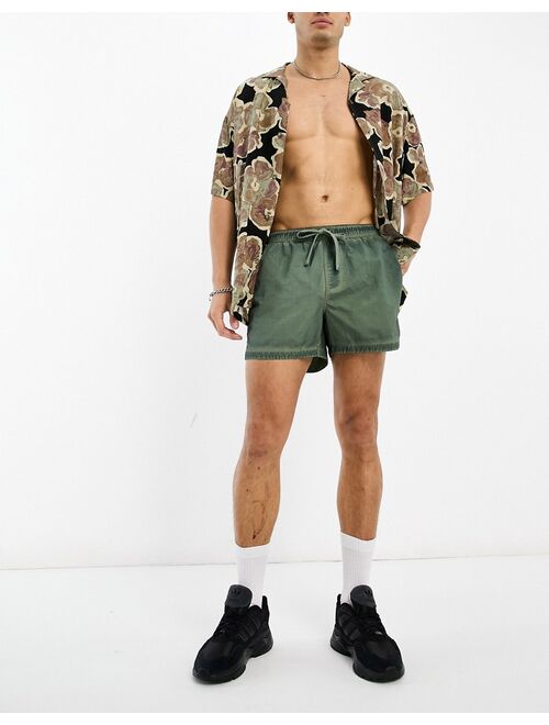 ASOS DESIGN swim shorts in short length in washed green