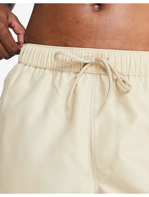 ASOS DESIGN swim shorts in short length in beige