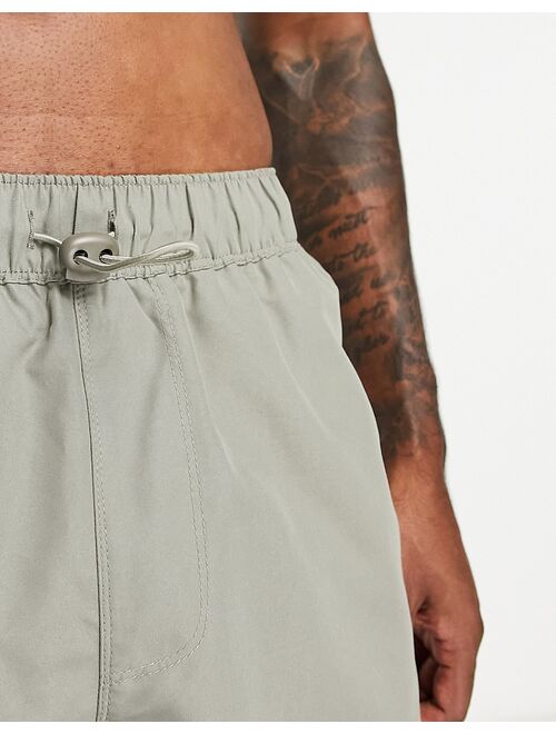 ASOS DESIGN swim shorts in short length with toggle waistband in light khaki