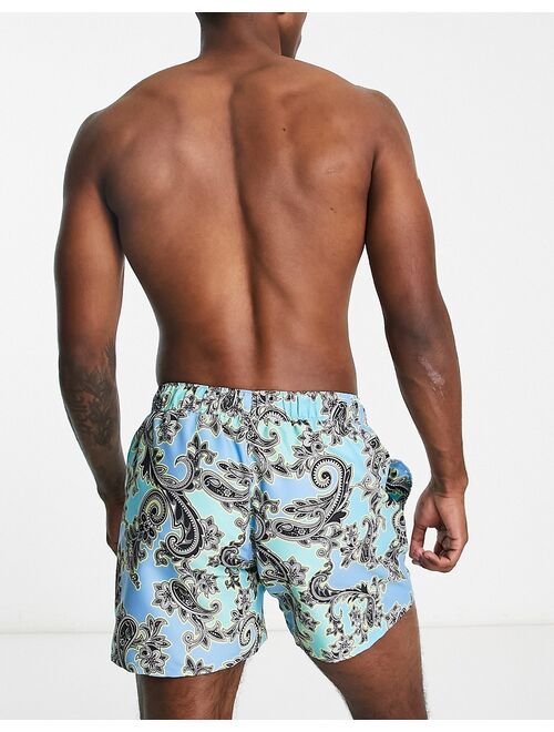 ASOS DESIGN swim shorts in short length with paisley print in blue