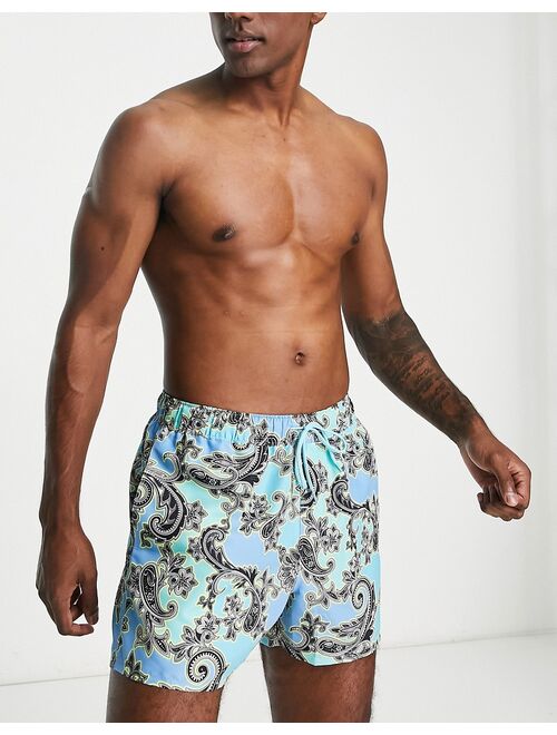 ASOS DESIGN swim shorts in short length with paisley print in blue